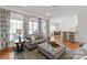 Open-concept living room featuring hardwood floors, a fireplace, and seamless access to dining and kitchen areas at 1304 Lookout Cir, Waxhaw, NC 28173