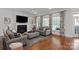 Bright living room with fireplace, large windows, stylish furnishings, and hardwood flooring at 1304 Lookout Cir, Waxhaw, NC 28173