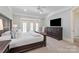 Serene bedroom boasts soft blue walls, a ceiling fan, and french doors that leads to a private outdoor space at 1304 Lookout Cir, Waxhaw, NC 28173