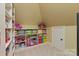Bright playroom featuring a built-in shelf stocked with toys, games and colorful storage bins at 1304 Lookout Cir, Waxhaw, NC 28173