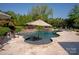 Backyard pool and patio area with outdoor seating and umbrella at 1304 Lookout Cir, Waxhaw, NC 28173