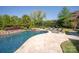 Backyard pool with patio and green landscaping. Ideal for outdoor fun and relaxation at 1304 Lookout Cir, Waxhaw, NC 28173