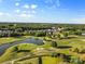 Scenic aerial shot of golf course, displaying lush green fairways, a serene pond, and meticulously maintained grounds at 1308 Stone Marker Dr, Monroe, NC 28112