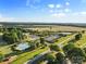 Overhead shot features a community pool, tennis courts, and manicured lawns amidst lush greenery at 1308 Stone Marker Dr, Monroe, NC 28112