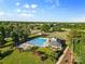 Aerial view of neighborhood pool with greenery, gazebo and walking trail at 1308 Stone Marker Dr, Monroe, NC 28112