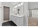 Well-lit bathroom with double vanity, hexagon tile flooring and closet nearby at 1308 Stone Marker Dr, Monroe, NC 28112