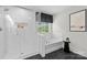 Bright bathroom featuring white subway tile shower, soaking tub and black hexagon floor at 1308 Stone Marker Dr, Monroe, NC 28112