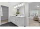 The bathroom has dual sinks, modern hardware, black hexagonal floors, and lots of light at 1308 Stone Marker Dr, Monroe, NC 28112