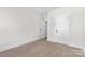 Minimal bedroom with neutral carpet, paint and two doors at 1308 Stone Marker Dr, Monroe, NC 28112