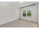 Well-lit bedroom with large window and neutral carpet at 1308 Stone Marker Dr, Monroe, NC 28112