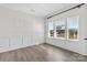 Bright bedroom with white trim, paneled walls, and light wood flooring at 1308 Stone Marker Dr, Monroe, NC 28112