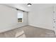Bedroom with neutral carpet and walls, a single window, and white trim at 1308 Stone Marker Dr, Monroe, NC 28112