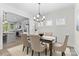 Dining room featuring a modern chandelier with a view into a bright kitchen at 1308 Stone Marker Dr, Monroe, NC 28112