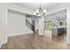 Open-concept dining area with light wood flooring and staircase access at 1308 Stone Marker Dr, Monroe, NC 28112