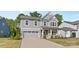 Charming two-story home with a manicured lawn and attached two car garage at 1308 Stone Marker Dr, Monroe, NC 28112
