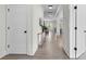 Bright hallway featuring hardwood floors and neutral decor, leading into an open-concept living space at 1308 Stone Marker Dr, Monroe, NC 28112