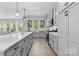 Spacious kitchen featuring a large island with bar seating, stainless appliances, and ample natural light at 1308 Stone Marker Dr, Monroe, NC 28112