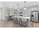 Modern kitchen with stainless steel appliances, gray cabinetry, and a central island with bar seating at 1308 Stone Marker Dr, Monroe, NC 28112