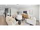 Open concept living room with light-colored furniture and hardwood floors at 1308 Stone Marker Dr, Monroe, NC 28112