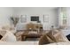 Bright living room with light colored furniture, tv, and hardwood floors at 1308 Stone Marker Dr, Monroe, NC 28112