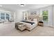 The main bedroom features neutral decor, a large bed, bench, and windows for lots of natural light at 1308 Stone Marker Dr, Monroe, NC 28112