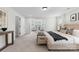 This main bedroom features neutral decor, a carpeted floor, and an entrance to a seating area at 1308 Stone Marker Dr, Monroe, NC 28112