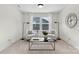 This sitting room features two white chairs, a black coffee table, neutral decor, and carpeted floors at 1308 Stone Marker Dr, Monroe, NC 28112
