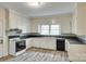 Kitchen with white cabinets and a sink under a window at 146 Walnut St, Chester, SC 29706
