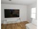 Bright living room featuring modern laminate flooring, a TV, white walls, and a white sofa at 149 Glenwood Dr, Rock Hill, SC 29732