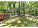 A spacious backyard features a storage shed and mature trees, offering a serene and private outdoor space at 16320 Peach Grove Ln, Charlotte, NC 28277