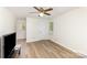 Airy bedroom with wood floors, ceiling fan, and natural light from multiple windows at 16320 Peach Grove Ln, Charlotte, NC 28277
