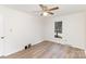 Bedroom with neutral walls, updated flooring, and a window with green outdoor views at 16320 Peach Grove Ln, Charlotte, NC 28277