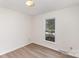 Bright bedroom with neutral walls, modern wood flooring, and natural lighting at 16320 Peach Grove Ln, Charlotte, NC 28277