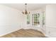 Bright dining area features wood floors, neutral paint, lots of natural light and a chandelier at 16320 Peach Grove Ln, Charlotte, NC 28277