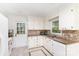 Classic kitchen with tiled floors, granite counters, mosaic backsplash, and white cabinetry at 16320 Peach Grove Ln, Charlotte, NC 28277