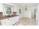 Bright kitchen features granite counters, tiled floors, mosaic backsplash, and white cabinets at 16320 Peach Grove Ln, Charlotte, NC 28277