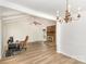 Bright living room with wood floors, vaulted ceiling, a fireplace, and a chandelier at 16320 Peach Grove Ln, Charlotte, NC 28277