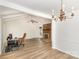 Bright living room with wood floors, vaulted ceiling, a fireplace, and a chandelier at 16320 Peach Grove Ln, Charlotte, NC 28277