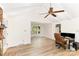 Bright living room features wood floors, high ceilings and transitions to an open dining area at 16320 Peach Grove Ln, Charlotte, NC 28277