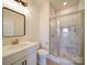 Bathroom features a vanity, sink, toilet, and a modern glass-enclosed shower with marble tiling at 1706 Ruben Rd, Monroe, NC 28112