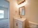 Bathroom featuring modern fixtures, a single sink vanity, and a well lit mirror at 1706 Ruben Rd, Monroe, NC 28112