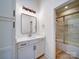 A well-lit bathroom with a vanity and a glass-enclosed shower with marble tiling at 1706 Ruben Rd, Monroe, NC 28112