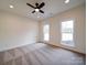 Bedroom with neutral tones, carpet, ceiling fan, and two windows providing natural light at 1706 Ruben Rd, Monroe, NC 28112