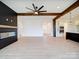 Open concept living room with wood beams, fireplace, and a kitchen with island at 1706 Ruben Rd, Monroe, NC 28112