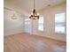 Open living room boasts hardwood floors, natural light, and elegant chandeliers at 1706 Ruben Rd, Monroe, NC 28112