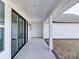 Covered porch with black framed sliding doors and ample space for relaxing outdoors at 1706 Ruben Rd, Monroe, NC 28112