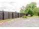 Spacious backyard with a dark wooden fence and gravel parking area at 18 Shannon Ct, Newton, NC 28658