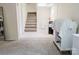 Spacious carpeted basement with stairs leading to another level, offering potential for customization at 18 Shannon Ct, Newton, NC 28658