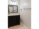 Bathroom vanity with a dark wooden cabinet, granite countertop, and decorative mirror at 18 Shannon Ct, Newton, NC 28658