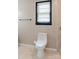 Simple bathroom with a modern toilet, neutral walls, and a window providing natural light at 18 Shannon Ct, Newton, NC 28658